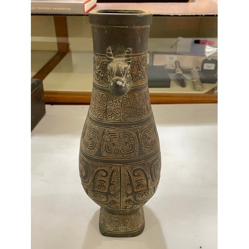 1006 - A Chinese Archaic style bronze vase, with relief decoration and dragon handles, height 30cm