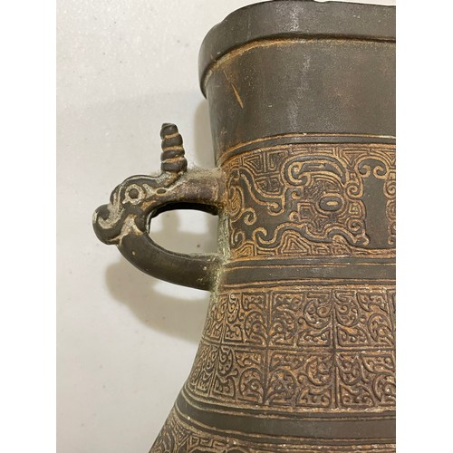 1006 - A Chinese Archaic style bronze vase, with relief decoration and dragon handles, height 30cm