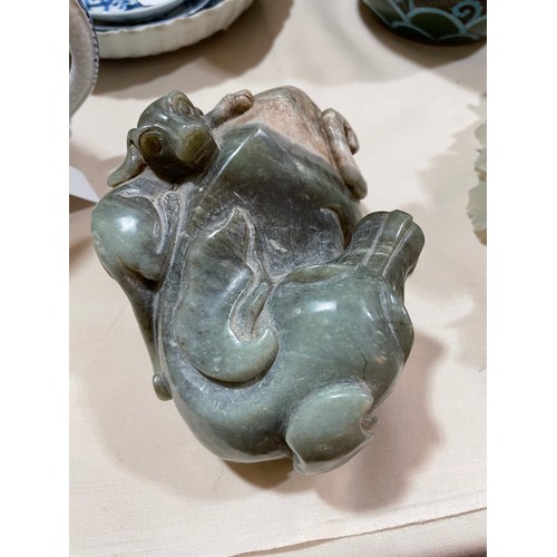 1313 - A large Chinese carved jade cabbage, length 27cm, and a carved stone dog with puppy, length 14cm (2)