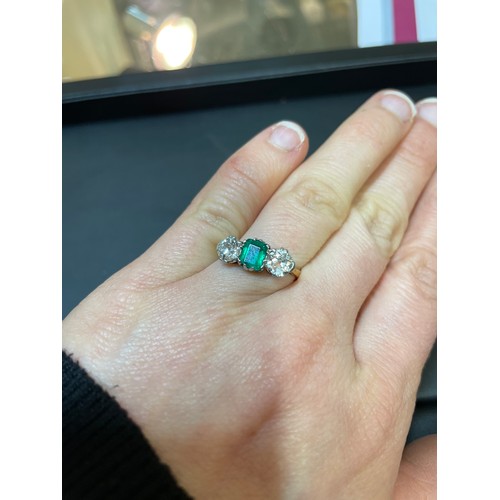 142 - An 18ct gold three stone emerald and diamond ring, platinum topped with emerald-cut emerald and old ... 