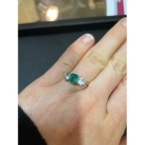 142 - An 18ct gold three stone emerald and diamond ring, platinum topped with emerald-cut emerald and old ... 