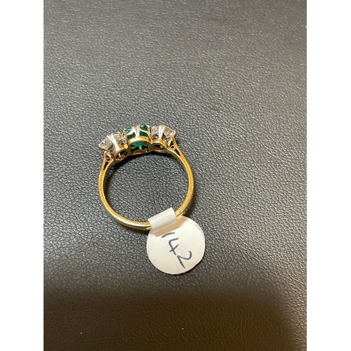 142 - An 18ct gold three stone emerald and diamond ring, platinum topped with emerald-cut emerald and old ... 