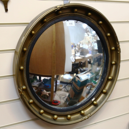 115 - A reproduction gilt-framed circular convex wall mirror, diameter 52cm