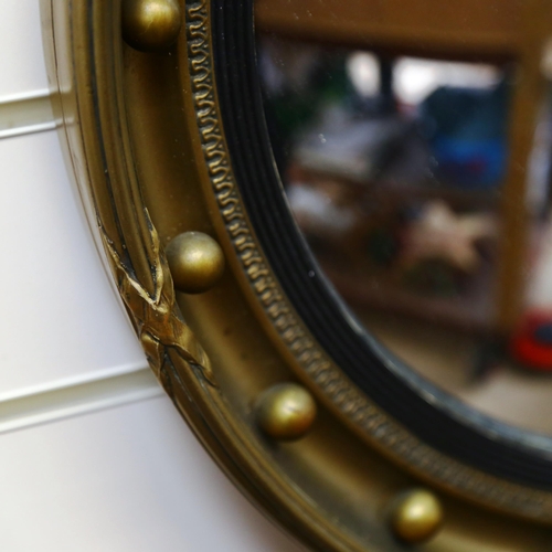 115 - A reproduction gilt-framed circular convex wall mirror, diameter 52cm