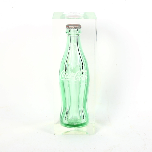 180 - A Vintage Lucite encased Coca-Cola bottle sculpture, height 22cm