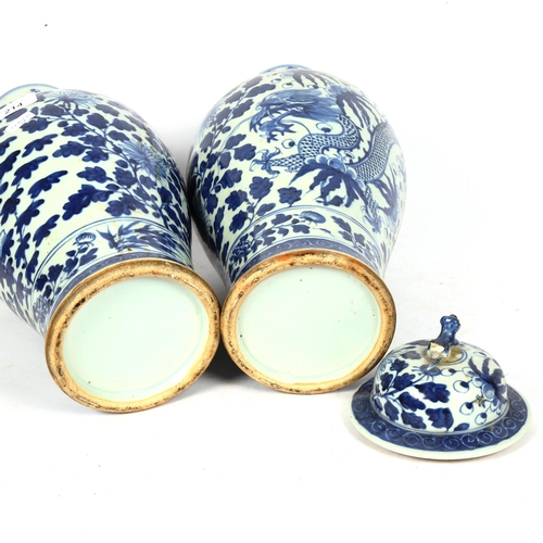 214 - A pair of Chinese blue and white 'Dragon' jars, height 37cm, and 1 lid (both chipped and cracked)