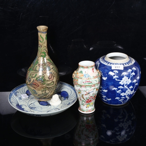 217 - A Chinese blue and white Prunus pattern ginger jar, Canton famille rose vase, crab plate, and an Ira... 