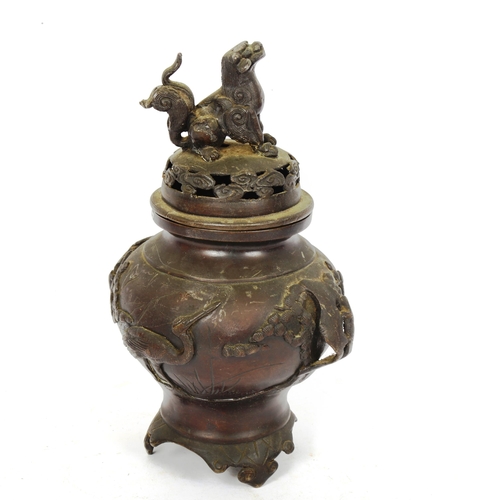 230 - A Chinese patinated bronze incense burner and cover, with Kylin and crane decoration, height 27cm