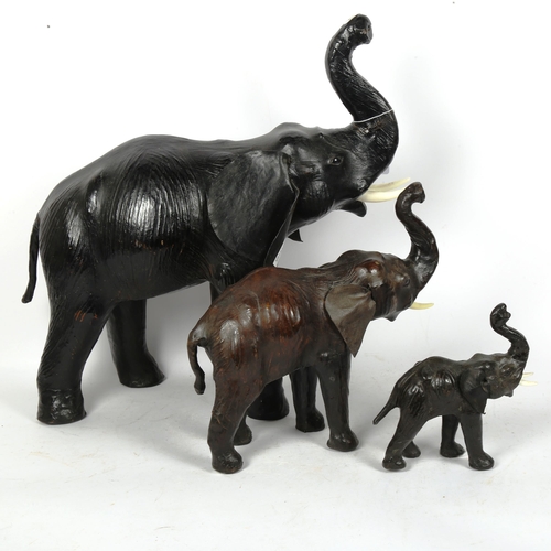 246 - A graduated set of 3 African leather-covered elephant figures, largest height 50cm