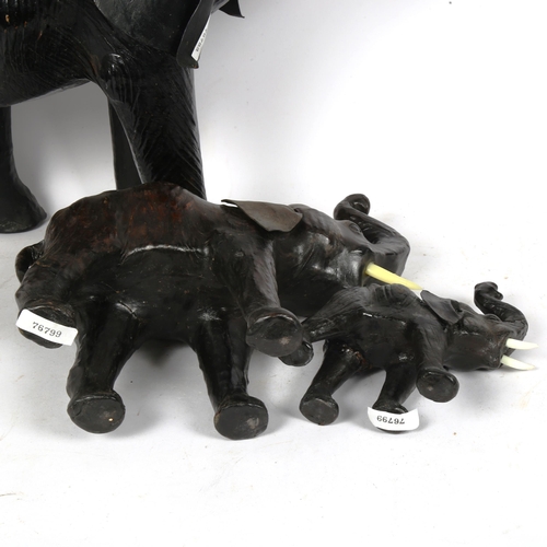 246 - A graduated set of 3 African leather-covered elephant figures, largest height 50cm