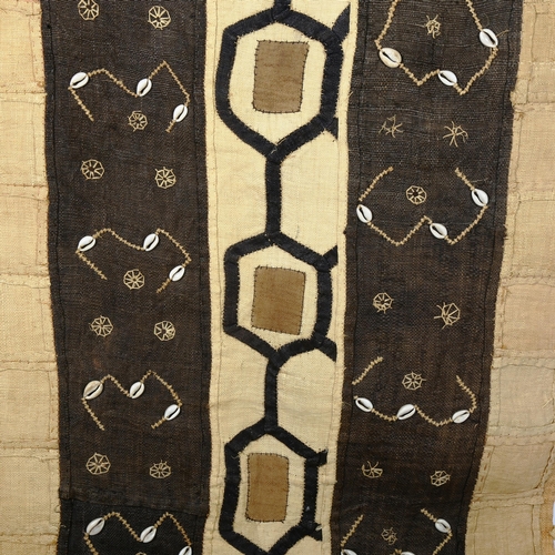 257 - An African woven and dyed grass and cowrie shell textile panel, 230cm x 68cm