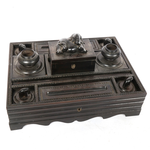 262 - An early 20th century Anglo-Indian ebony desk stand, with elephant decoration, 23cm x 30cm