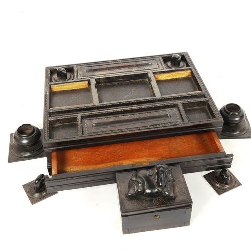 262 - An early 20th century Anglo-Indian ebony desk stand, with elephant decoration, 23cm x 30cm