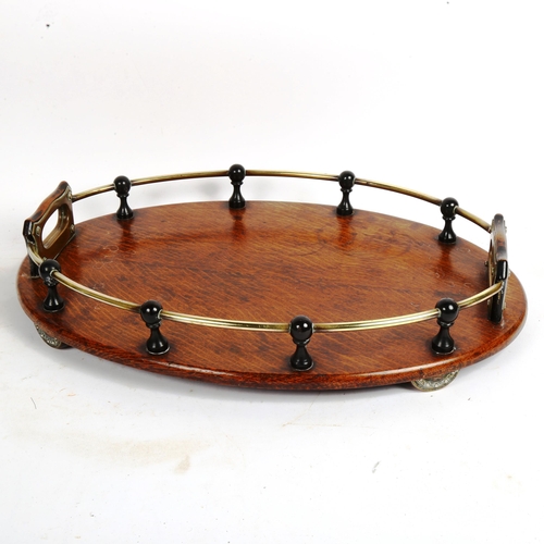 70 - A brass-mounted oak oval drinks' tray, 45cm x 30cm