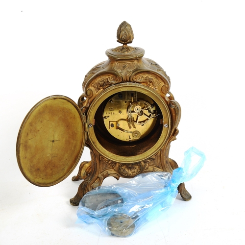 348 - A French Art Nouveau gilded spelter 8-day mantel clock, height 26cm, with pendulum and key