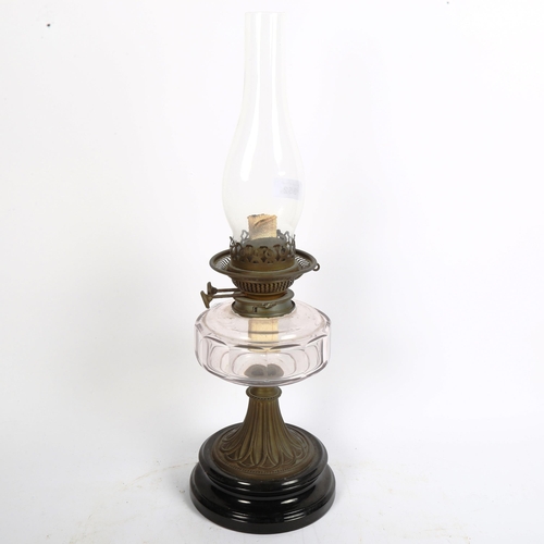 352 - An early 20th century brass oil lamp, with black pottery base and faceted glass font, overall height... 