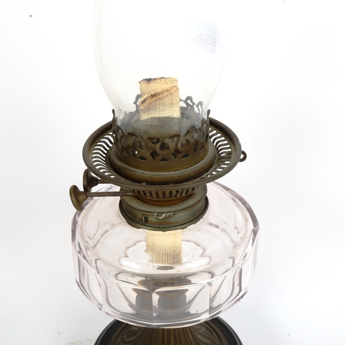 352 - An early 20th century brass oil lamp, with black pottery base and faceted glass font, overall height... 