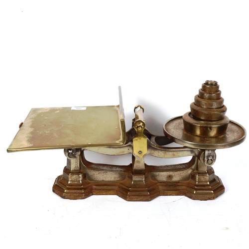 386 - A Victorian set of cast-iron and brass balance scales, with graduated set of weights, length 54cm