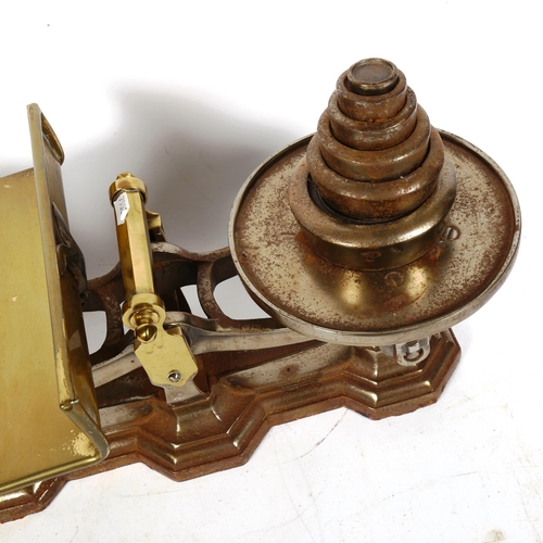 386 - A Victorian set of cast-iron and brass balance scales, with graduated set of weights, length 54cm