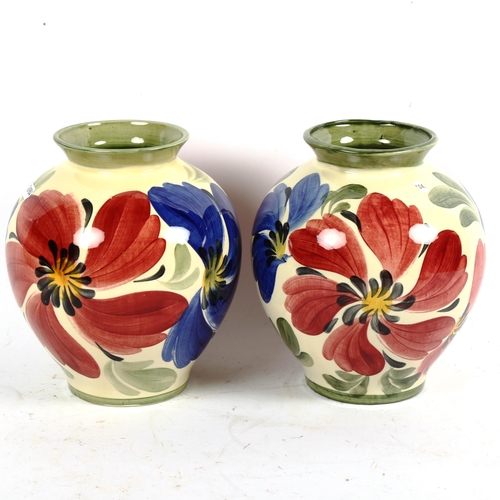 686 - A pair of Siltone pottery vases with painted floral designs, 21cm