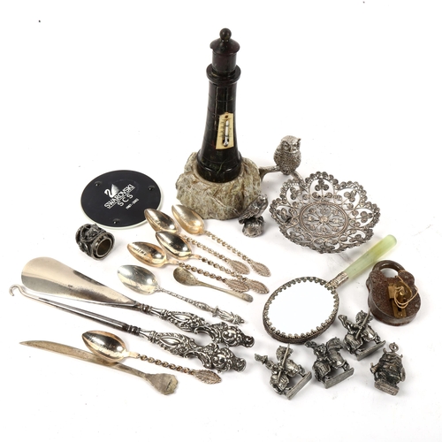 1014 - A silver-handled button hook and shoe horn, teaspoons, serpentine lighthouse etc