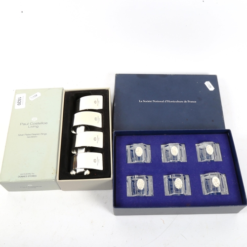 1020 - PAUL COSTELLOE - A set of 6 silver plated napkin rings, in original box, and a set of 6 glass napkin... 