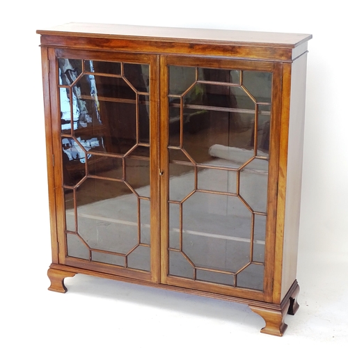 2013 - A reproduction mahogany 2-door bookcase, with glazed panelled doors, and 3 adjustable shelves, W104c... 