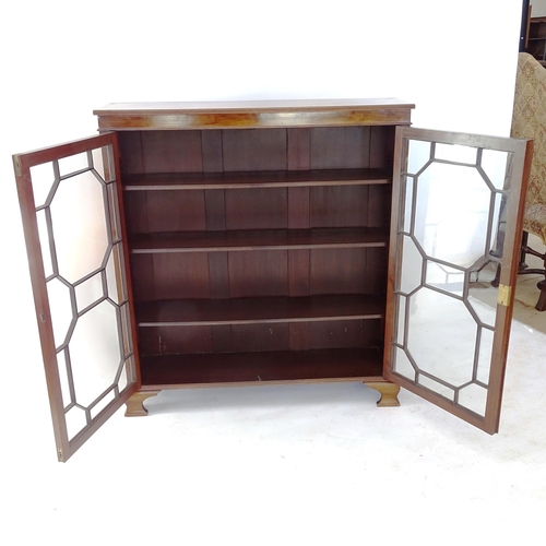 2013 - A reproduction mahogany 2-door bookcase, with glazed panelled doors, and 3 adjustable shelves, W104c... 