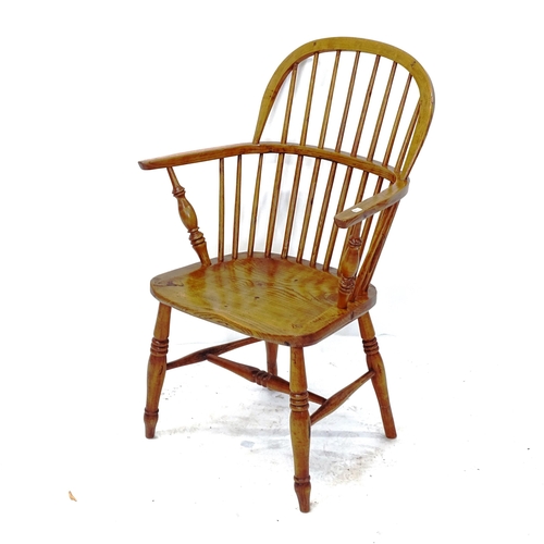 2022 - An oak spindle-back bow-arm chair