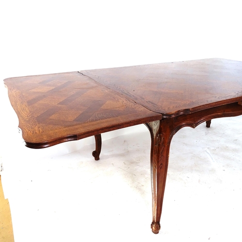 2031 - A large French oak parquetry-topped draw leaf dining table, on cabriole legs, L150cm extending to 25... 