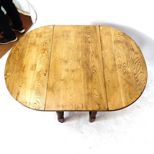 2037 - An oak gateleg table on barley twist legs, W90cm, H73cm, overall length 123cm