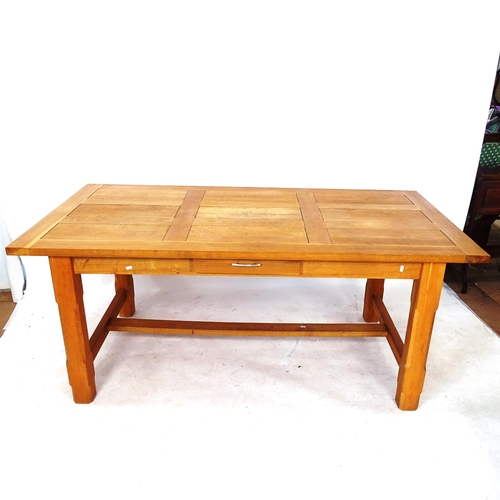 2044 - A large solid oak dining table, with 2 spare leaves, on H-shaped stretcher with single frieze drawer... 