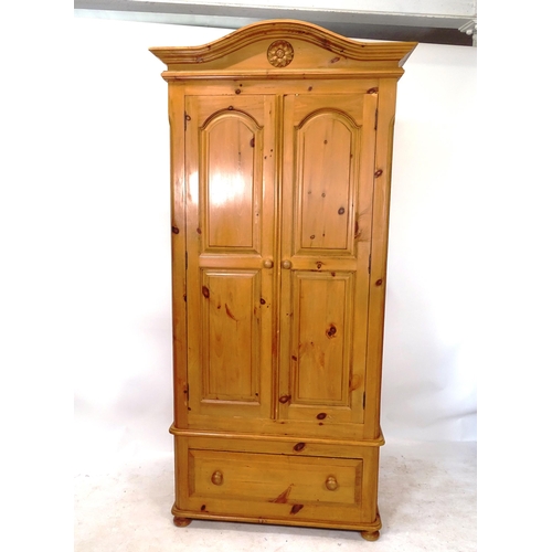 2045 - A polished pine 2-door wardrobe with drawer fitted base, W102cm, H215cm, D62cm