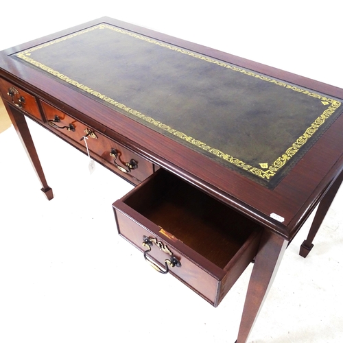 2046 - A reproduction mahogany writing table, with an inset green leather skiver, 3 frieze drawers, on squa... 