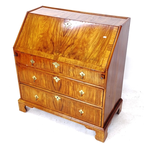 2053 - An Antique walnut bureau, the crossbanded fall-front revealing a fitted interior with well, 2 long d... 