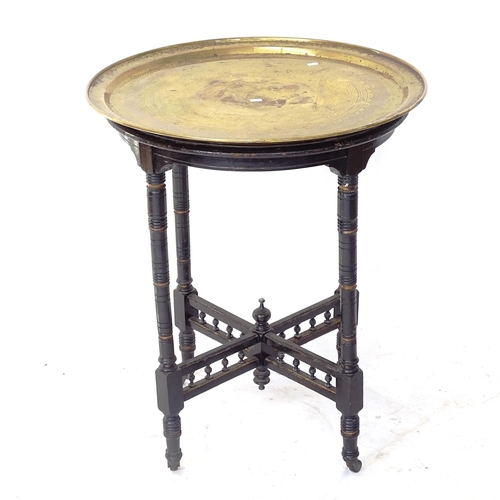 2058 - A Victorian circular brass-topped occasional table, on ebonised base, D62cm, H75cm