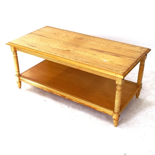 2059 - A modern pine 2-tier coffee table, on turned legs, L106cm, H46cm, D54cm