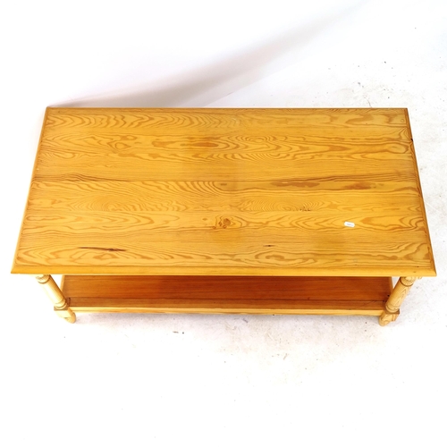 2059 - A modern pine 2-tier coffee table, on turned legs, L106cm, H46cm, D54cm