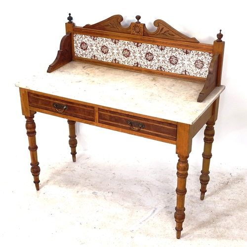 2067 - An Art Nouveau pine washstand, with raised tile back, marble top and 2 frieze drawers, W107cm, H108c... 