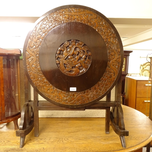 2796 - A Chinese design circular folding occasional table, with relief carved decoration, W60cm