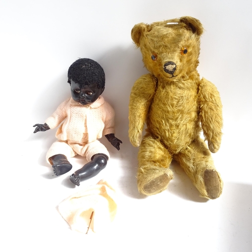 102 - A Vintage straw-filled teddy bear, and a Pedigree doll