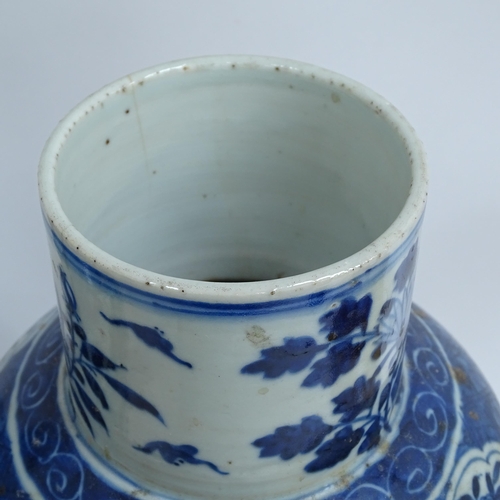 214 - A pair of Chinese blue and white 'Dragon' jars, height 37cm, and 1 lid (both chipped and cracked)