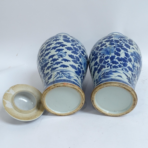 214 - A pair of Chinese blue and white 'Dragon' jars, height 37cm, and 1 lid (both chipped and cracked)