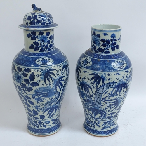 214 - A pair of Chinese blue and white 'Dragon' jars, height 37cm, and 1 lid (both chipped and cracked)