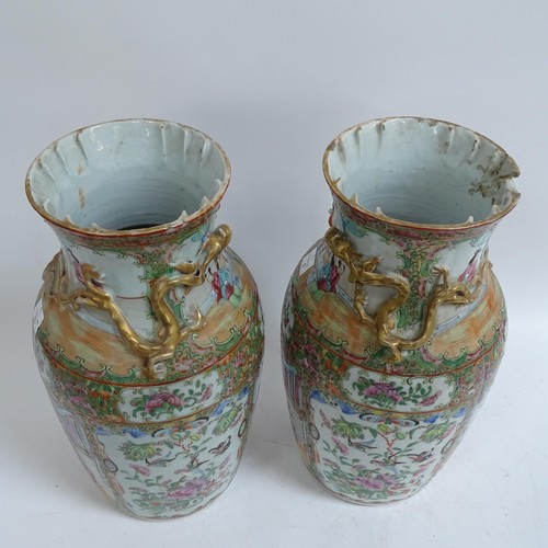 213 - A pair of Chinese Canton famille rose vases, with enamelled courtyard decoration, with applied gilde... 