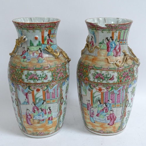 213 - A pair of Chinese Canton famille rose vases, with enamelled courtyard decoration, with applied gilde... 