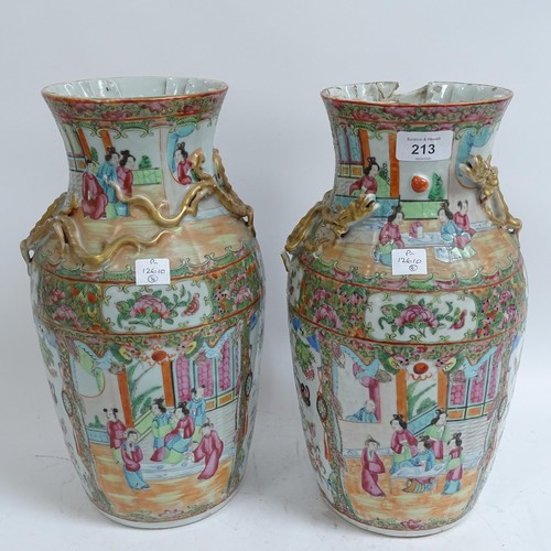 213 - A pair of Chinese Canton famille rose vases, with enamelled courtyard decoration, with applied gilde... 