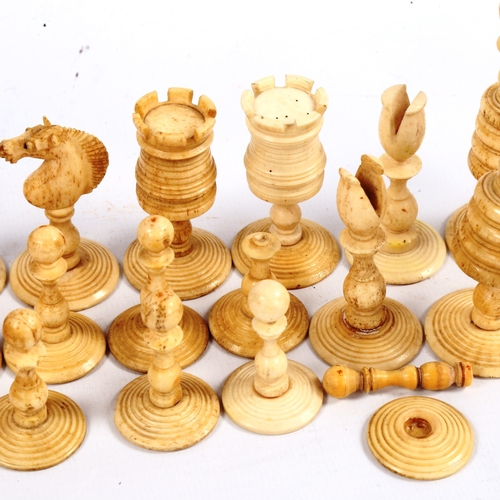 1021 - A 19th century red and white stained bone chess set, King height 8cm, in original poker-work decorat... 