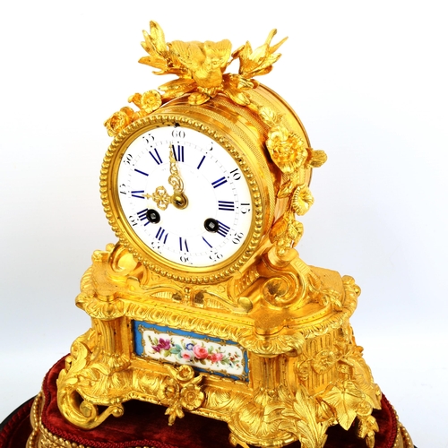 63 - A 19th century French ormolu and porcelain 8-day mantel clock, by Samuel Marti, white enamel dial wi... 