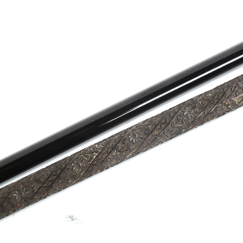 1067 - A 19th century walking stick, with unmarked white metal floral decorated handle, and a relief carved... 